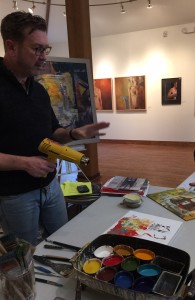 Dale Roberts demonstrating how to paint with encaustic.